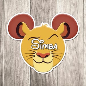 May include: A Simba-themed sticker depicting a smiling lion face with mouse ears. The sticker is yellow, with a red nose and ears, and the name "Simba" in white script. The sticker is set against a wooden background.