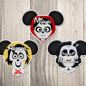 May include: Three character stickers inspired by the movie Coco, featuring Miguel, Hector, and Mama Imelda. Each character is depicted with a skull face, black mouse ears, and their names written above their heads. The stickers are on a wooden background.