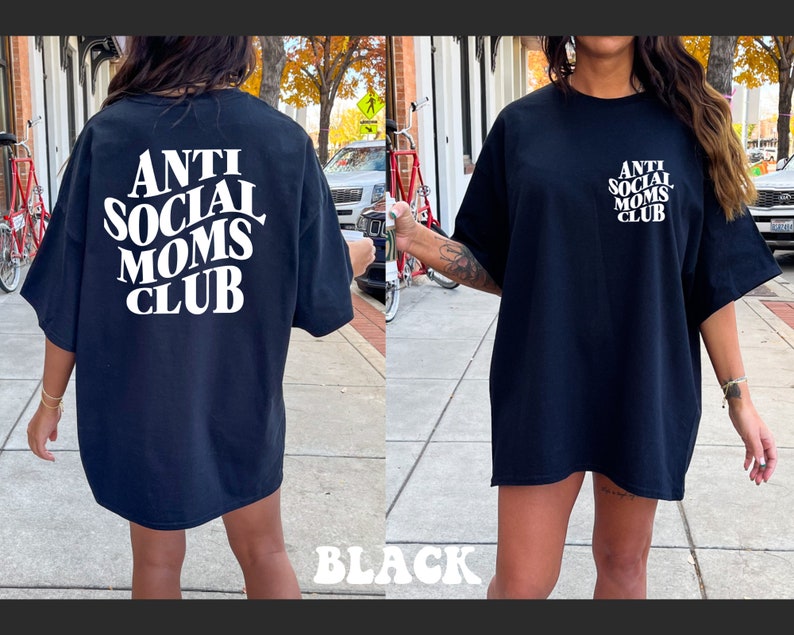 May include: Black oversized t-shirt with white text that reads "Anti Social Moms Club".