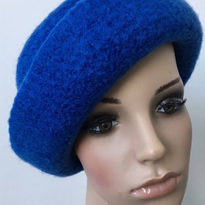 May include: A bright blue wool beret hat. The hat is soft and has a slightly slouchy fit.