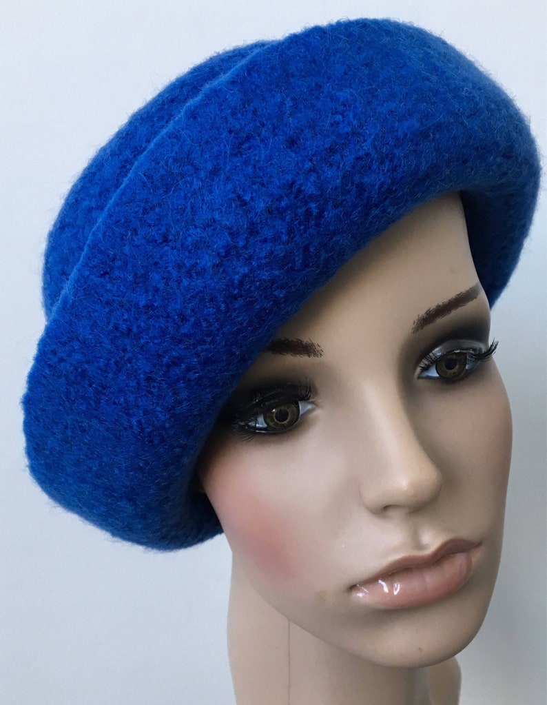 May include: A bright blue wool beret hat. The hat is soft and has a slightly slouchy fit.