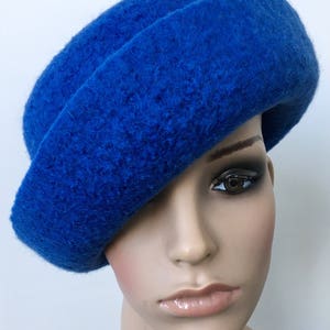May include: A bright blue felt hat with a wide brim and a soft, textured surface.