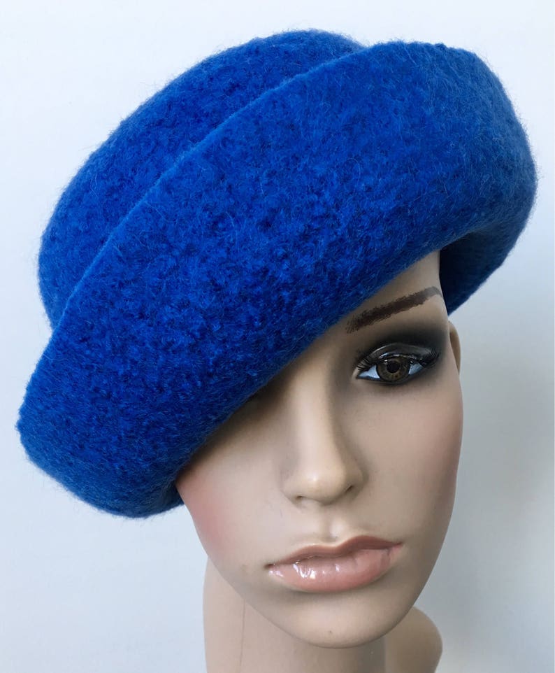May include: A bright blue felt hat with a wide brim and a soft, textured surface.
