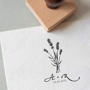 May include: A black and white illustration of a bouquet of lavender flowers with the initials "A + R" and the date "10.08.2021" below.