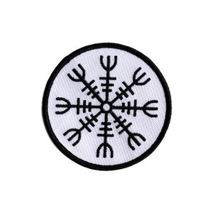 May include: A black and white embroidered patch with a circular design. The design is a stylised compass with eight points, each with a unique shape. The patch is on a white background.