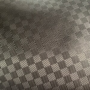 May include: Black fabric with a geometric pattern of small squares.