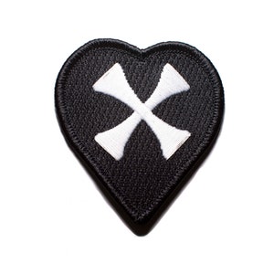 May include: Black heart-shaped patch with a white cross in the center.