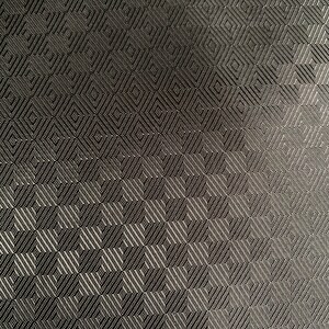 May include: Black fabric with a geometric pattern of small squares and diamonds.