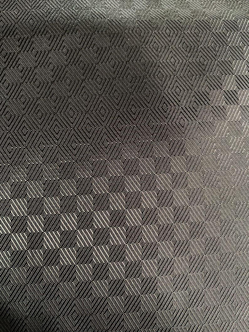 May include: Black fabric with a geometric pattern of small squares and diamonds.
