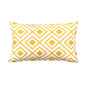 May include: A yellow and white geometric patterned throw pillow. The pillow has a diamond pattern.