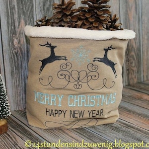 May include: A beige fabric sack with a white faux fur trim, embroidered with two black reindeer, a snowflake, and the text "Merry Christmas Happy New Year".