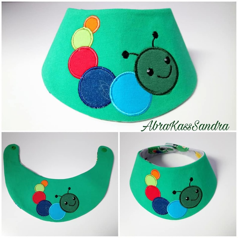 May include: Green fabric baby bib with a colorful caterpillar design. The caterpillar is made of felt and has a smiling face. The bib has a snap closure.