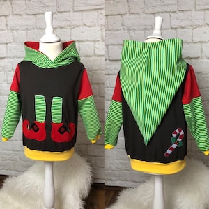 May include: A brown hooded sweatshirt with green and white striped sleeves and hood. The front of the sweatshirt has a red and green elf boot design. The back of the sweatshirt has a red and white candy cane design.
