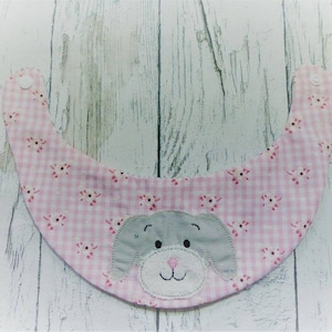 May include: Pink and white gingham baby bib with a gray felt puppy face applique.