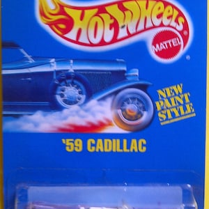 Hot Wheels #266 1959 Cadillac rosa nuevo en tarjeta azul