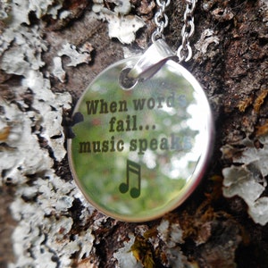 message mirror necklace, stainless steel, &quot;When words fail... music speaks&quot;