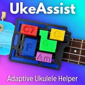 May include: A black plastic chord-playing device labeled UkeAssist and Adaptive Ukulele Helper attached to a light blue ukulele neck. The device features colorful, raised buttons marked with the musical chords C7, C, G, F, and Am.