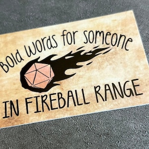 Sticker reading "BoldWords for Someone in Fireball Range" with an image of a flaming d20