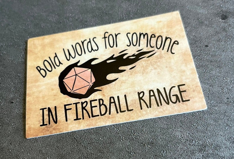 Sticker reading "BoldWords for Someone in Fireball Range" with an image of a flaming d20