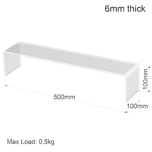 May include: A clear acrylic display stand, measuring 50cm long, 10cm wide, and 10cm high, with a thickness of 6mm. The stand is designed to hold items up to 0.5kg. The dimensions are clearly labeled in the image.