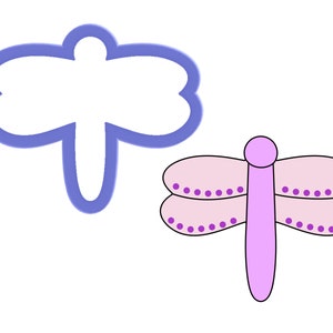 May include: A purple dragonfly cookie cutter with a pink dragonfly illustration. The cookie cutter is a simple outline of a dragonfly with a rounded body and two sets of wings.