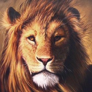 May include: A detailed painting of a lion's face, showcasing a golden mane and intense gaze. The artwork features warm tones of brown and gold, with a focus on the lion's facial features and fur texture. The lion's eyes are a warm brown.