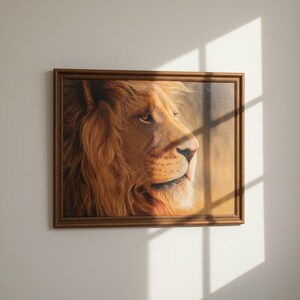 May include: A framed painting of a lion's profile, showcasing a detailed depiction of its face and mane. The artwork features warm tones of brown and gold, with a focus on the lion's eye and facial features. The frame is a dark brown color.