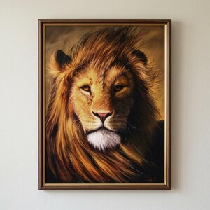 May include: A framed painting of a lion's head. The lion has a golden mane and fur, with a white patch of fur on its chest. The painting is in a brown wooden frame and is set against a neutral background.