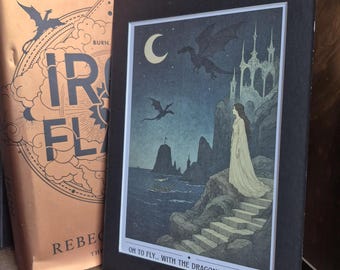 May include: A fantasy art print in a black frame, featuring a woman in a white dress standing on stone steps, with dragons flying in a night sky. The print includes a castle, a crescent moon, and the text "OH TO FLY... WITH THE DRAGONS IN THE SKY."