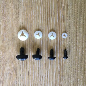 May include: Assortment of white and black plastic safety eyes for crafts. The white eyes are flat and come in three sizes. The black eyes are three-dimensional and come in two sizes.