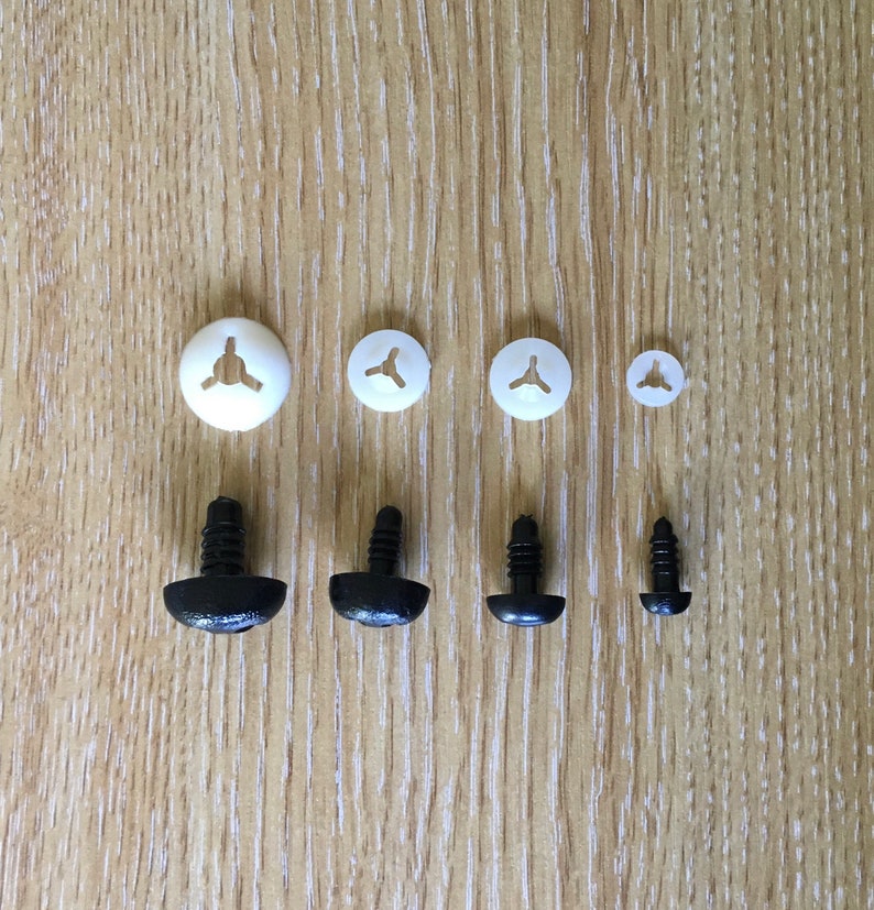 May include: Assortment of white and black plastic safety eyes for crafts. The white eyes are flat and come in three sizes. The black eyes are three-dimensional and come in two sizes.