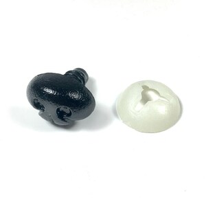 May include: A black plastic safety nose with a screw-on back and a white plastic washer.