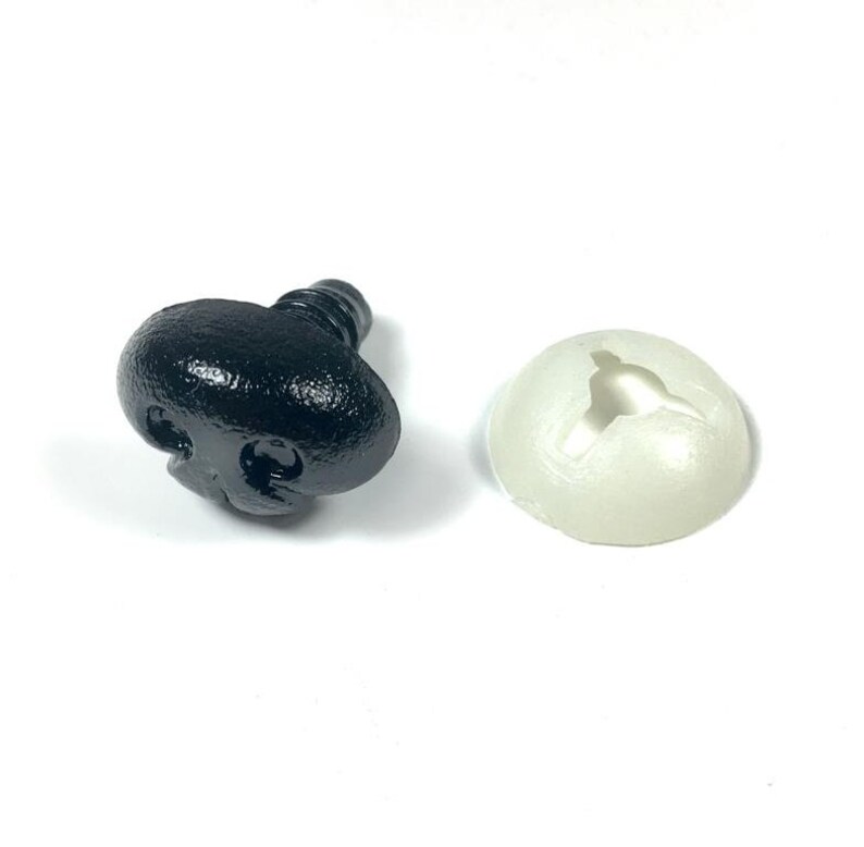 May include: A black plastic safety nose with a screw-on back and a white plastic washer.