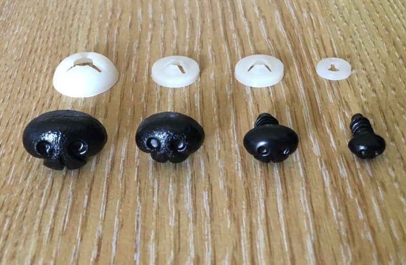 May include: Assortment of black plastic safety eyes and noses for stuffed animals. The eyes come in two sizes and the noses have a textured surface.