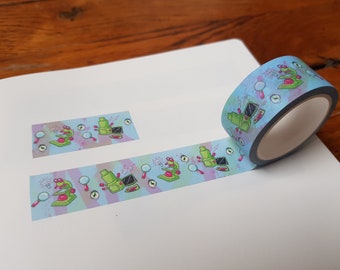 May include: A roll of washi tape with a light blue background and a repeating pattern of green microscopes, pink eyes, and magnifying glasses. The tape is partially unrolled, showing the pattern.