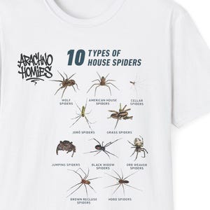 May include: White t-shirt featuring a graphic of ten types of house spiders. The shirt includes the text "Arachno Homies" in a stylized font above the spider illustrations and the text "10 Types of House Spiders".