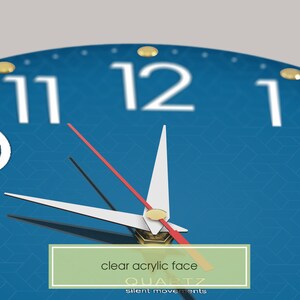 May include: A blue clock face with gold accents and black and red hands. The clock face has a clear acrylic finish and the text "QUARTZ" and "silent movements" printed on it.