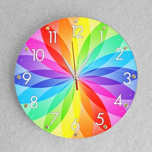 May include: A colourful rainbow clock with white numbers and black hands. The clock face is a circular design with a rainbow pattern.