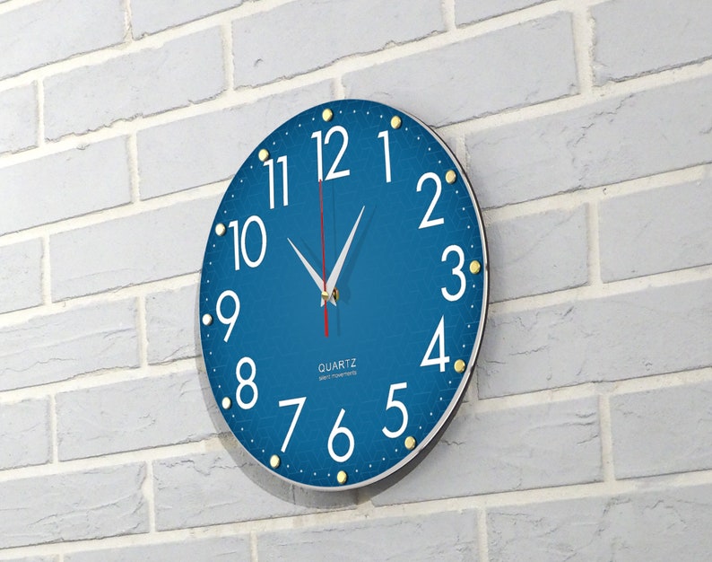 May include: A blue round clock with white numbers and gold accents. The clock face has a textured pattern and the words "QUARTZ" and "JAPAN MOVEMENT" are printed on the face.