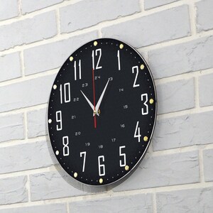 May include: A black and white clock with gold accents and a red second hand. The clock face has numbers 1 through 12 and 17 through 24.