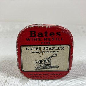 May include: A vintage red Bates Wire Refill tin for a Bates stapler. The tin features the text "Bates Wire Refill For Bates Stapler" and an illustration of a stapler. The Bates Mfg. Company, Orange, N.J., U.S.A. is printed on the bottom.