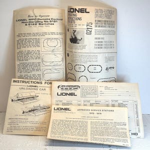 May include: A collection of vintage Lionel train instruction manuals and paperwork. The manuals include instructions for remote control, switches, and unloading cars. The documents are printed on aged paper with black text and illustrations.