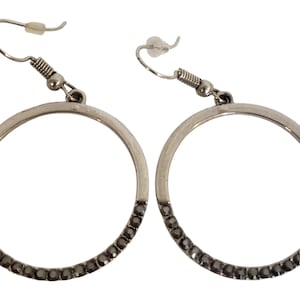 Silver toned circle dangle earrings with black crystals