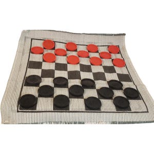 May include: A checkers game set with a black and white checkered playing surface. The game pieces are red and black discs. The playing surface is on a gray and white striped fabric.