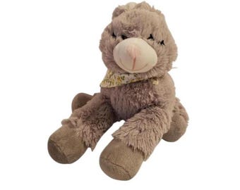 Conejito de peluche gris con bufanda floral amarilla