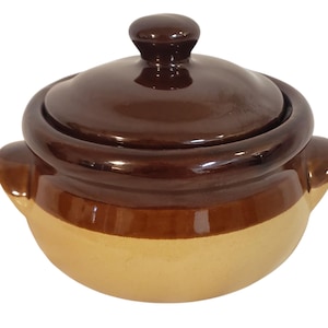 May include: A white ceramic mug with a black handle and the text "But First, Coffee" in a black, bold font. The mug is sitting on a white surface. The mug is approximately 4 inches tall.