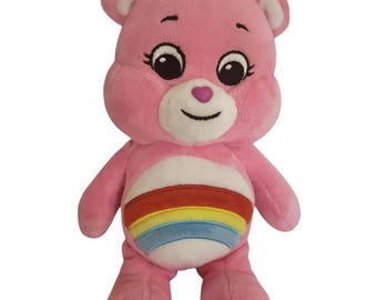 Osito Cariñoso Alegre de Peluche Rosa con Barriga Arcoíris, 25 cm (10 pulgadas)