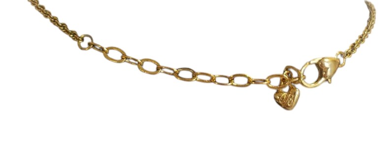 May include: Close-up of a gold necklace clasp and chain. The necklace has a delicate rope chain design that connects to an oval-link extender chain. A small heart-shaped charm hangs near the clasp.
