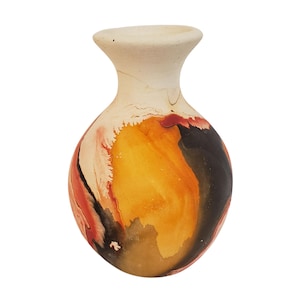 May include: A ceramic vase with a cream-coloured top and a bulbous body. The body features a vibrant abstract design with orange, red, and black hues. The vase has a smooth, glossy finish and a narrow neck.