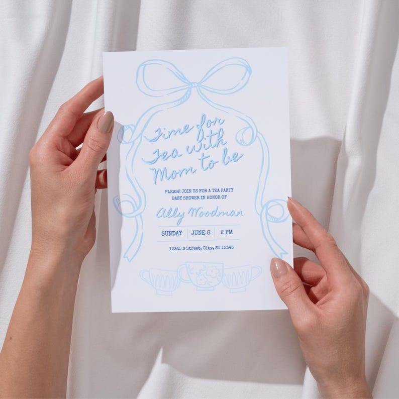 May include: A white invitation card with light blue text and illustrations. The text reads "Time for Tea with Mom to be" and invites guests to a baby shower for Ally Woodman on Sunday, June 8 at 2 PM.
